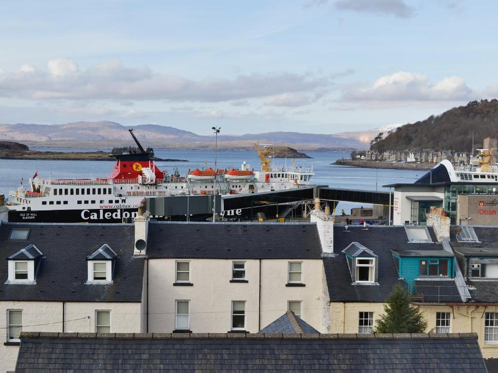 a cruise ship is docked in a harbor at Ferry View in Oban
