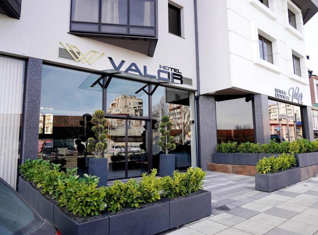 a store front of a building with plants in the windows at Хотел VALOR in Montana