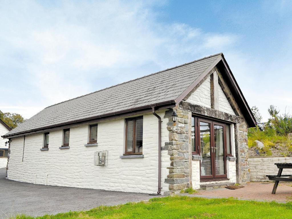 a white building with a gray roof at The Cart Shed in Ferryside