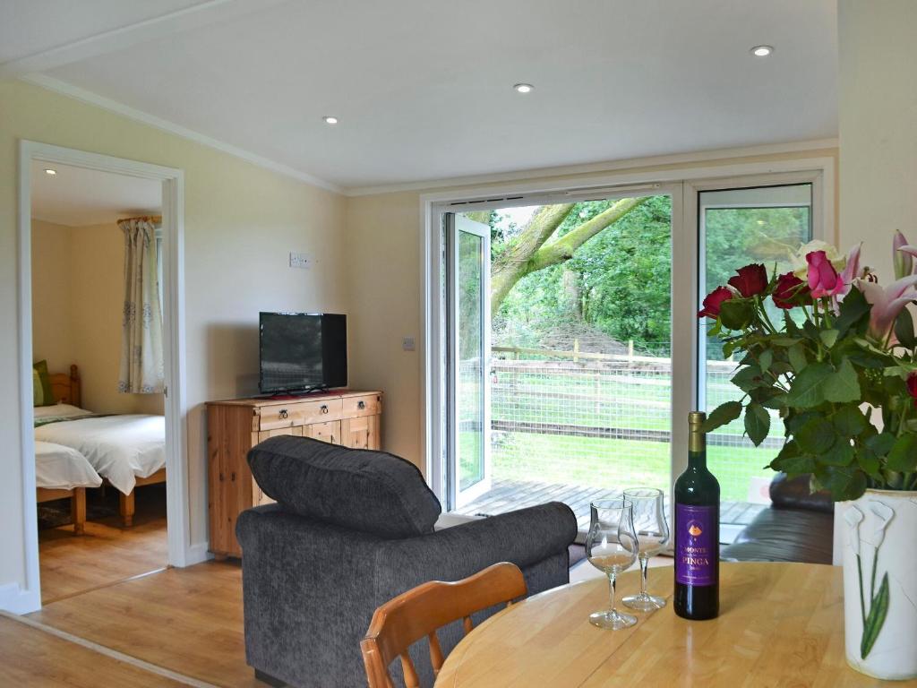 a living room with a table and a couch at Swallows Nest in Hoel-galed