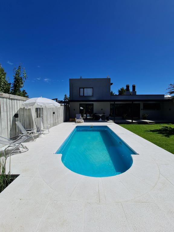 a swimming pool in the backyard of a house at Olivo Apartment in Esquel