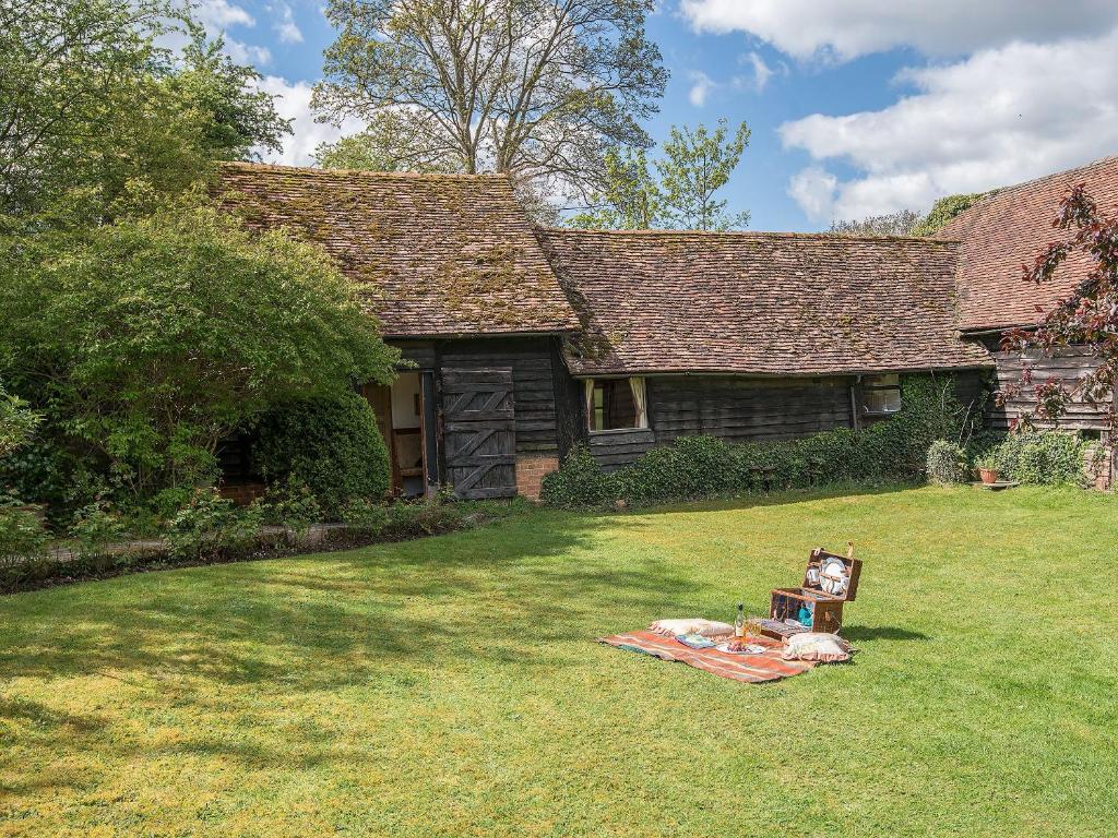 a house with a blanket in front of a yard at Pheasants Hill Old Byre in Hambleden