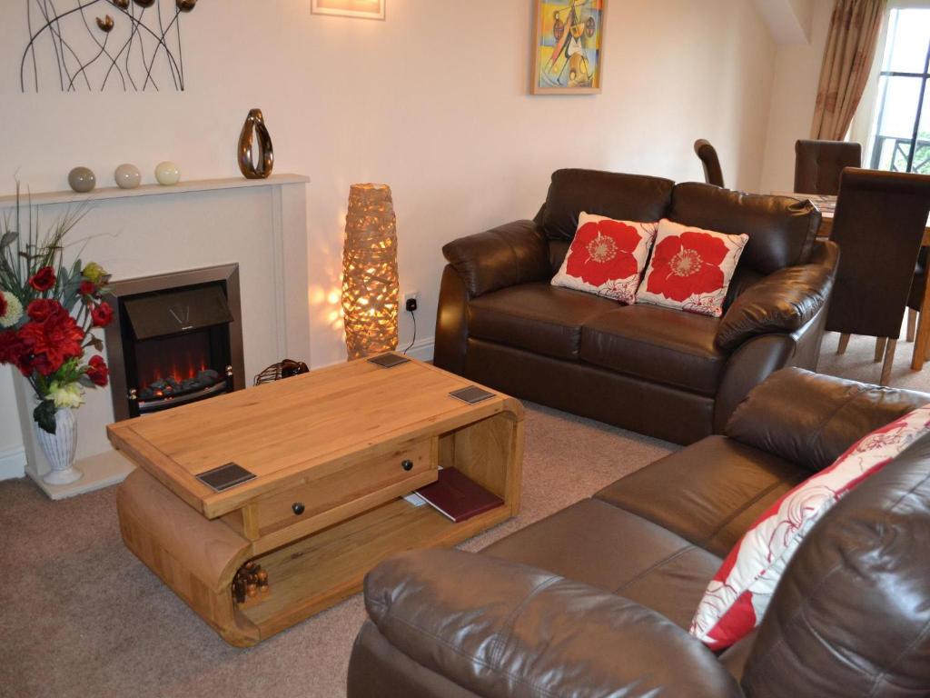 a living room with a couch and a coffee table at College Gate in Windermere