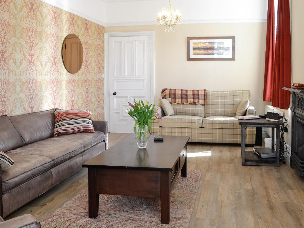 a living room with a couch and a coffee table at Bag End in Keswick