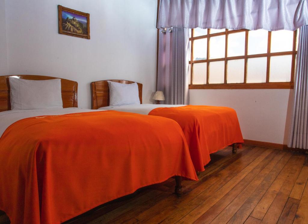 Letto o letti in una camera di Centenario Inn