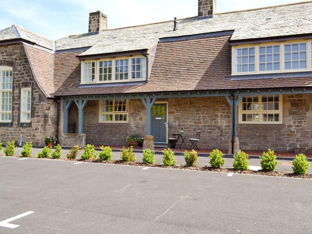 a brick house with a driveway in front of it at Abacus in Two Dales