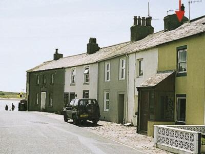 a car parked in front of a group of houses at Ashlea in Ravenglass