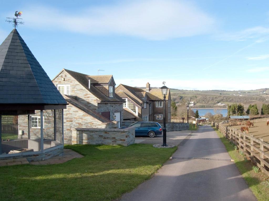 a house with a car parked next to a street at Forge Cottage - 28221 in Shaldon