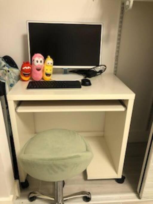 a desk with a computer and a keyboard and a chair at Naples Dream at WTC with Heated Pool SPA Sauna 7 bicycles and 3 mls to beach in Naples