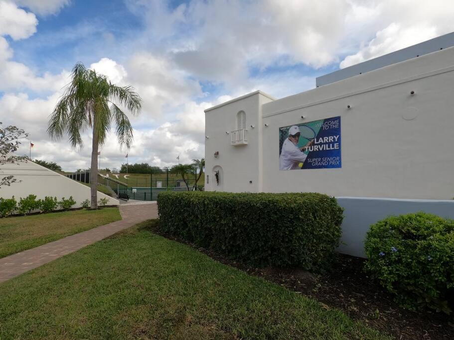 a white building with a sign on the side of it at Naples Dream at WTC with Heated Pool SPA Sauna 7 bicycles and 3 mls to beach in Naples