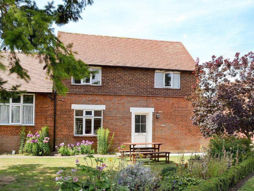 a brick house with a picnic table in front of it at Eventide in Biggleswade
