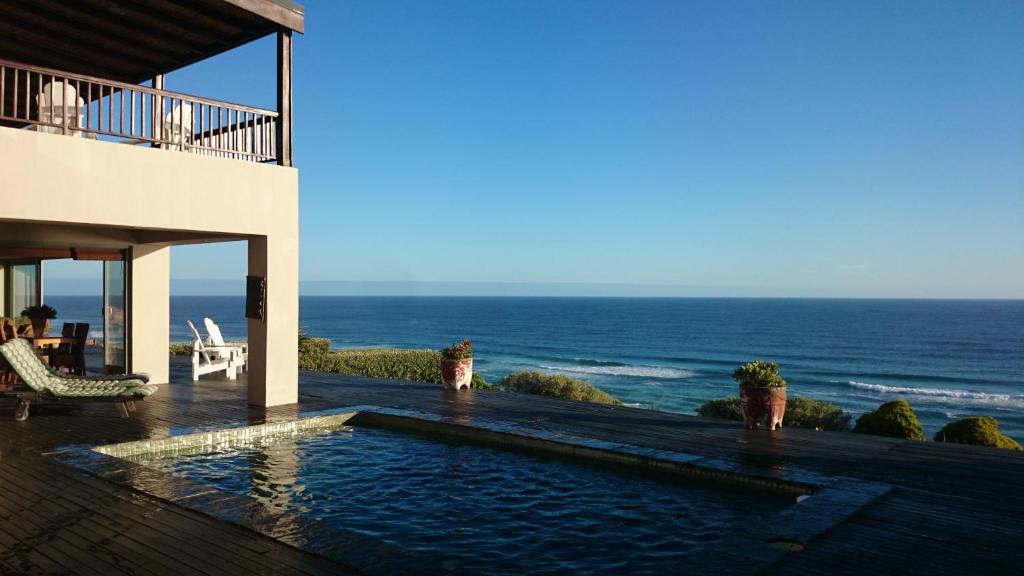 a house with a swimming pool next to the ocean at Dover on Sea B&B in Sedgefield