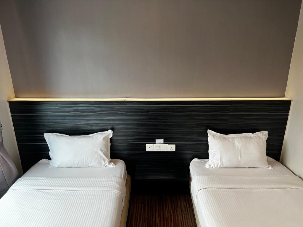 Postel nebo postele na pokoji v ubytování Signature Hotel