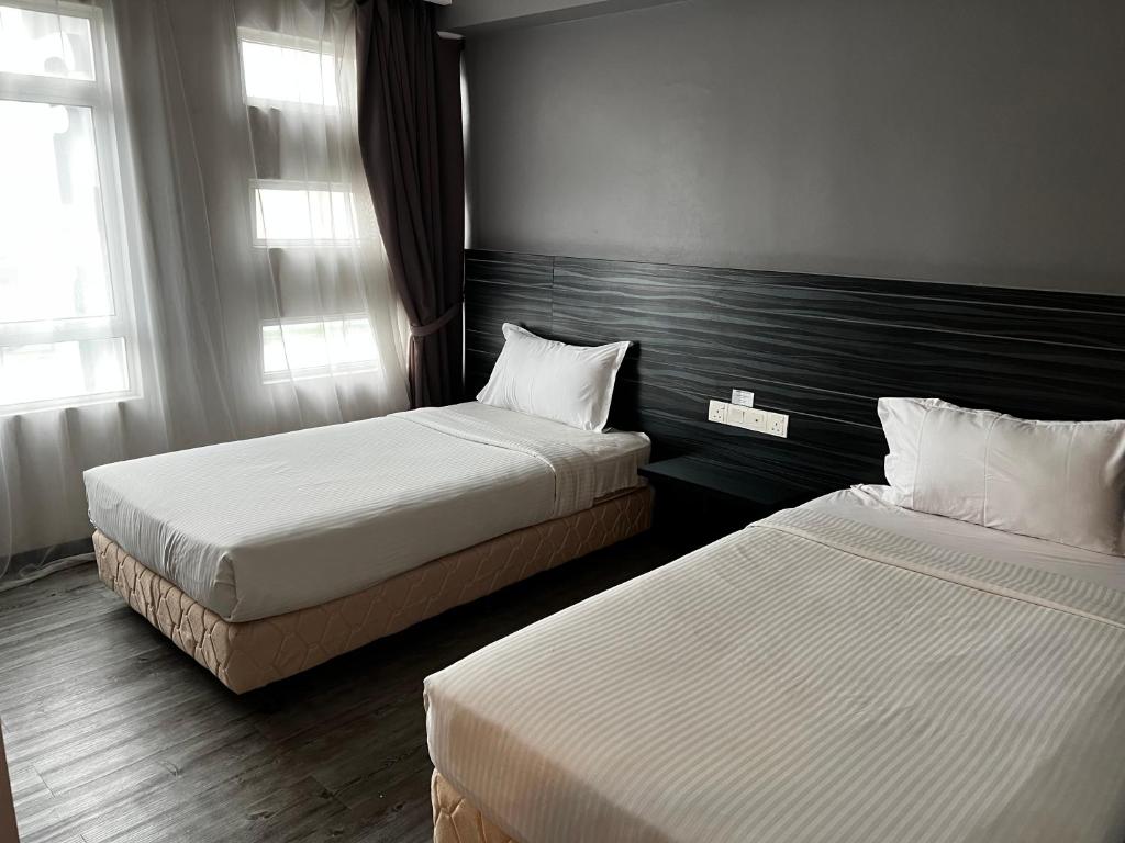 Postel nebo postele na pokoji v ubytování Signature Hotel