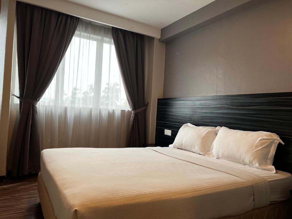 Postel nebo postele na pokoji v ubytování Signature Hotel