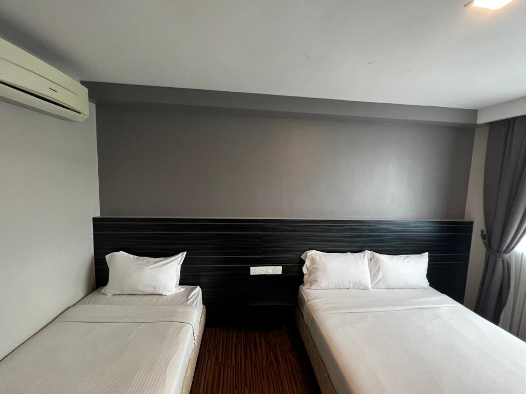 Postel nebo postele na pokoji v ubytování Signature Hotel