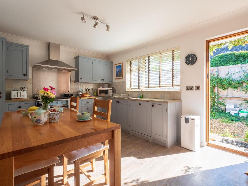 a kitchen with a wooden table and a dining room at Greenridge in Totland