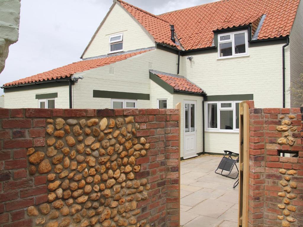 a brick fence in front of a house at Pirates Lookout in Wells next the Sea