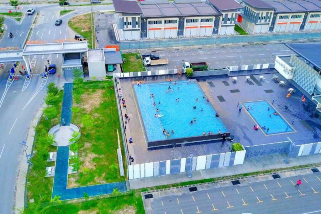 an overhead view of two swimming pools in a city at Luxury UUC Homestay KKIP Telipok Kota Kinabalu in Kota Kinabalu