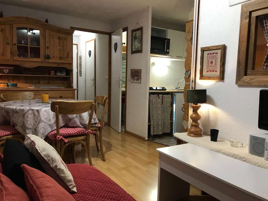 a kitchen and a living room with a table and chairs at Appartement Arêches-Beaufort, 2 pièces, 5 personnes - FR-1-342-144 in Beaufort