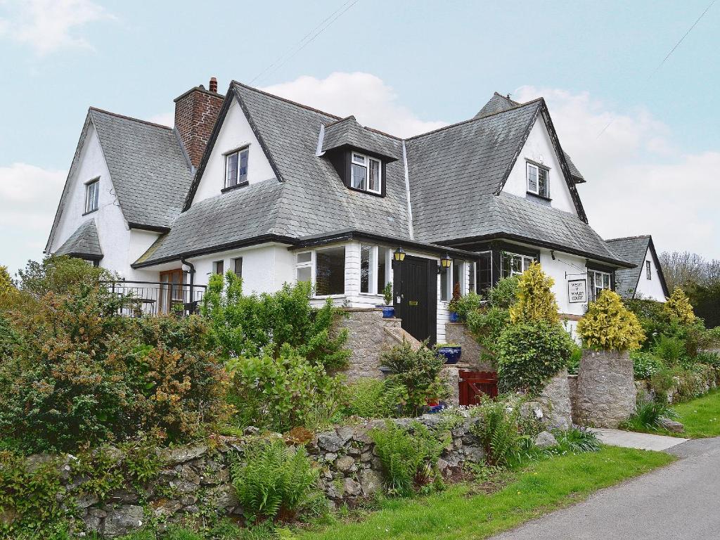 a white house with a gray roof at Wern Y Wylan Court in Llanddona