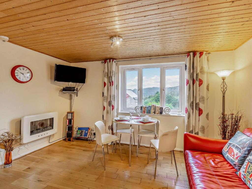 a living room with a table and a couch at Strawberries And Cream in Bowness-on-Windermere