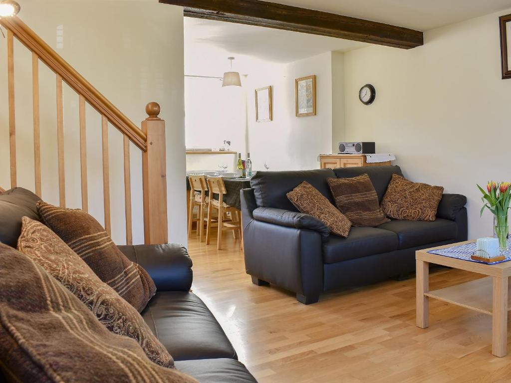 a living room with a couch and a table at Biskey Howe Cottage in Bowness-on-Windermere