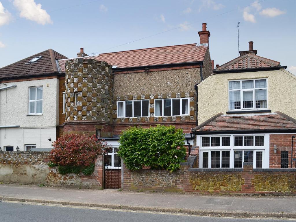 a brick house on the side of a street at The Mistress House in Hunstanton