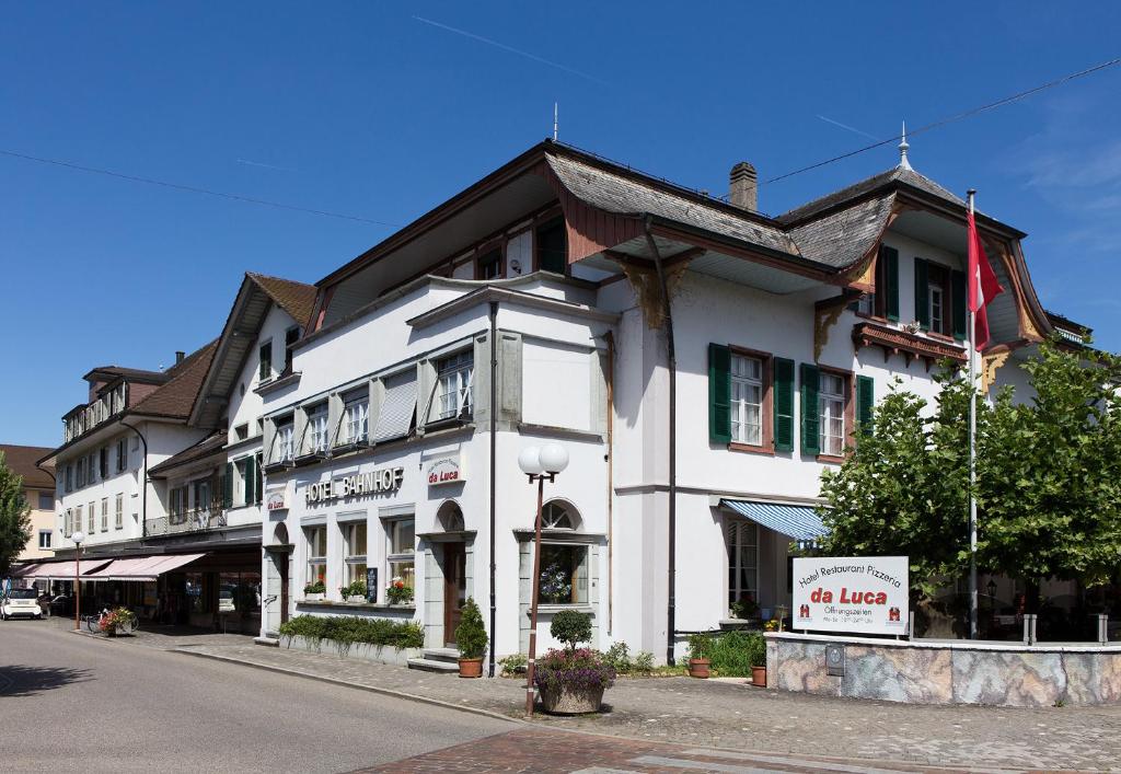 ein weißes Gebäude an der Straßenseite in der Unterkunft Hotel da Luca in Herzogenbuchsee