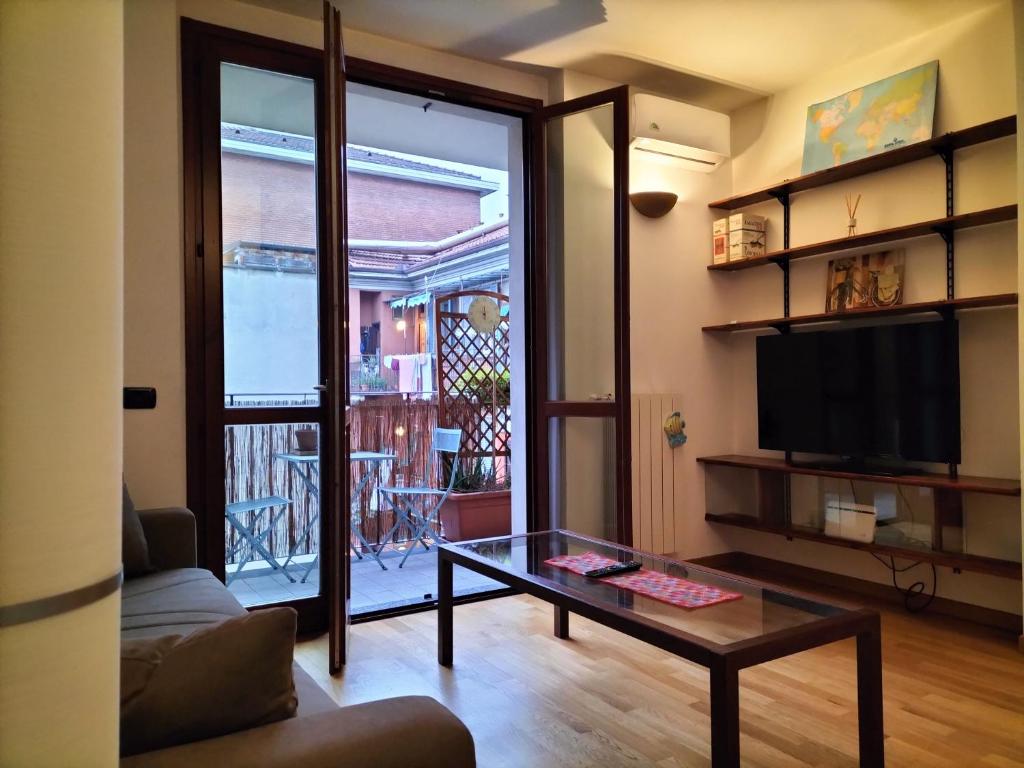 a living room with a coffee table and a television at Big Bright Flat in Milano close to Loreto square in Milan
