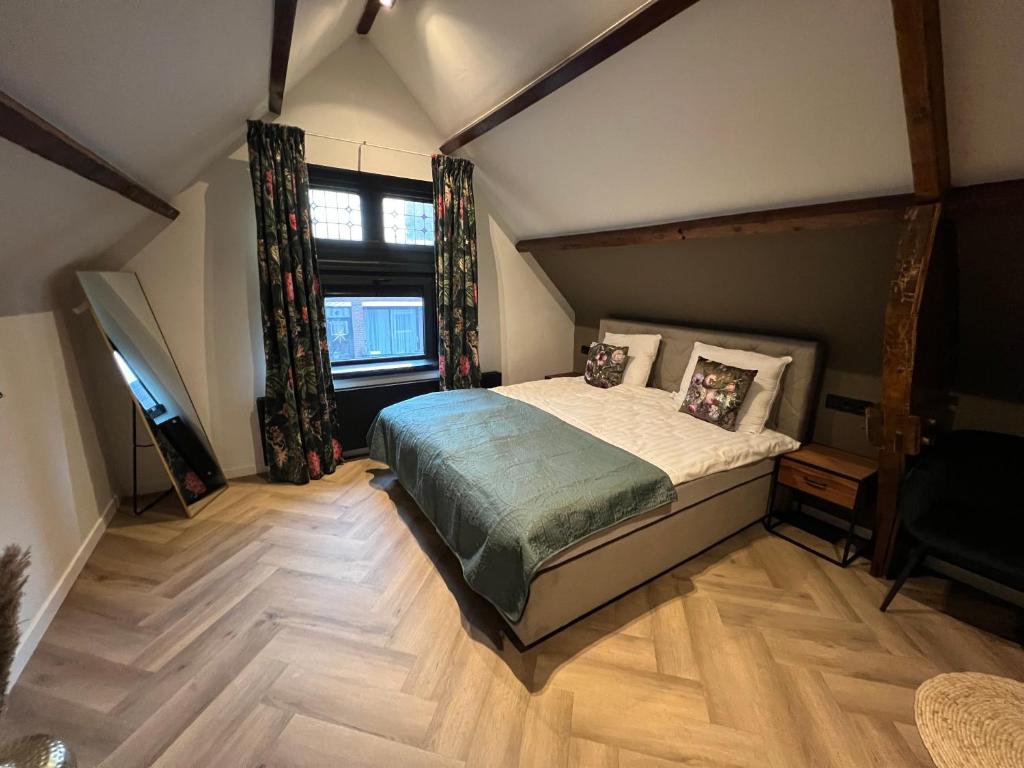 a bedroom with a bed and a large window at Boutique Hotel de Kade Zaandam-Amsterdam in Zaandam