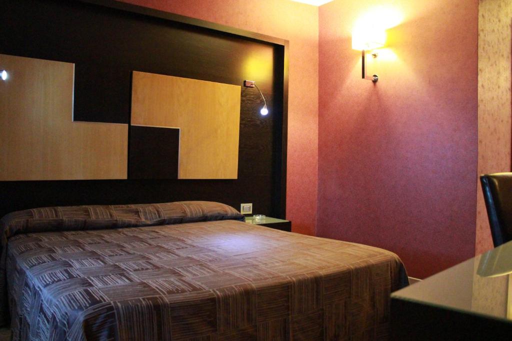 Letto o letti in una camera di Hotel Ginepro