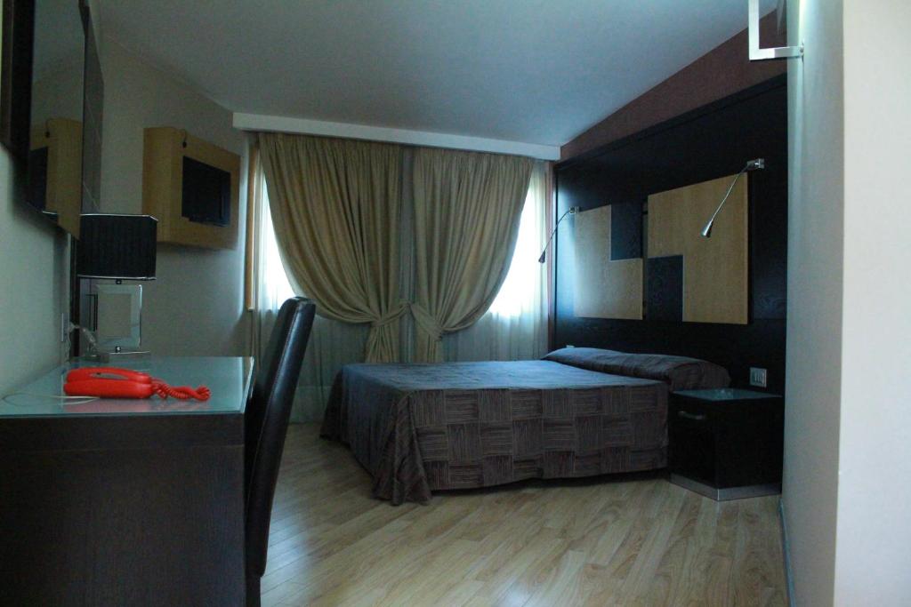 Кровать или кровати в номере Hotel Ginepro