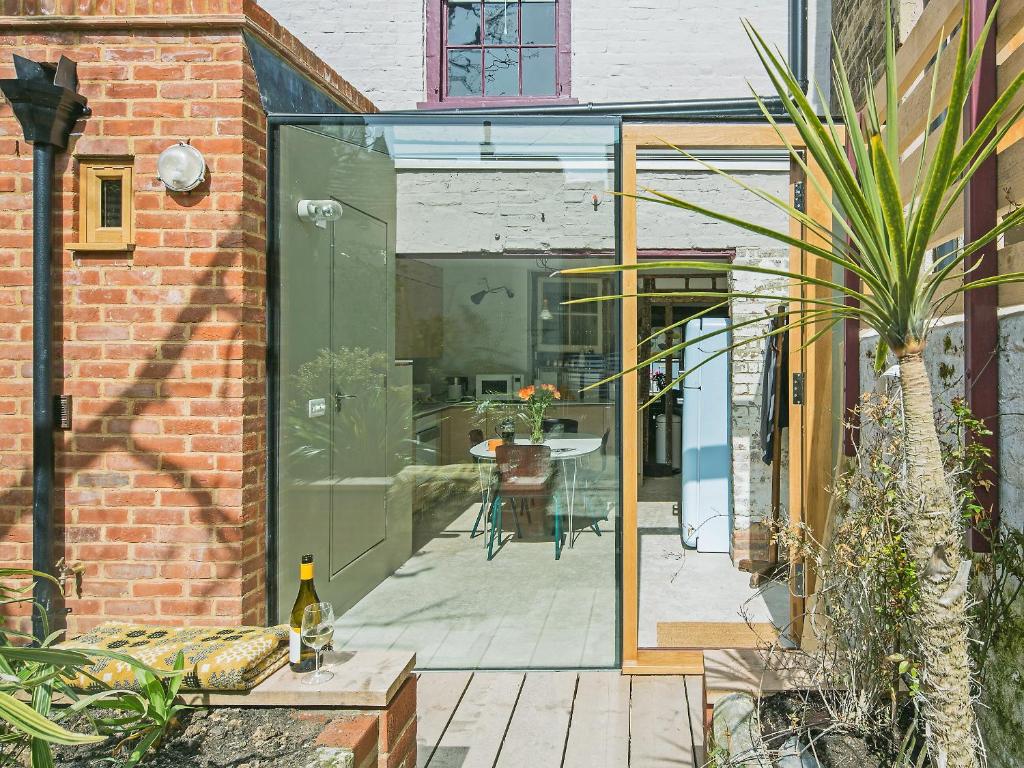 a glass extension to a house with a patio at Smugglers Cottage in Margate