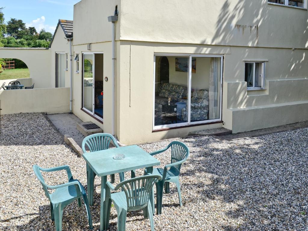 a table and chairs in front of a house at Appletree Apartment in Stokeinteignhead