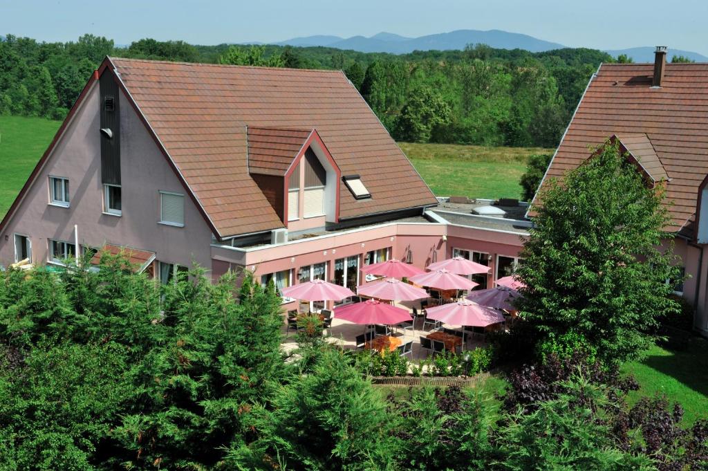 an aerial view of a hotel with pink umbrellas at Hotel Restaurant Le Coquelicot in Burnhaupt-le-Haut