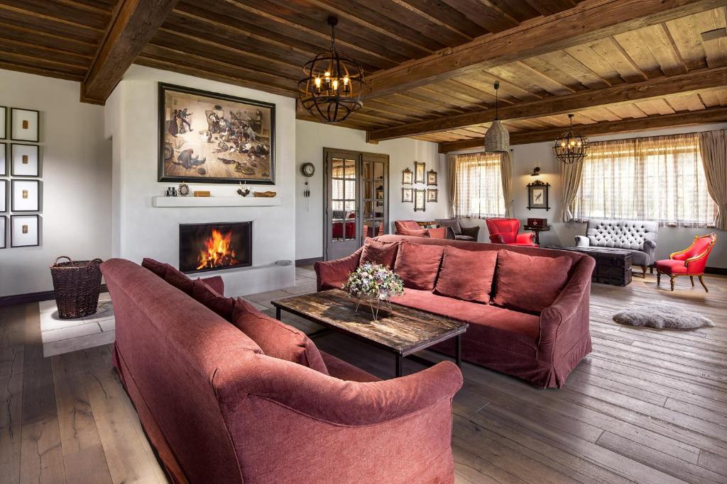 a living room with a couch and a fireplace at Statek Blatiny in Sněžné