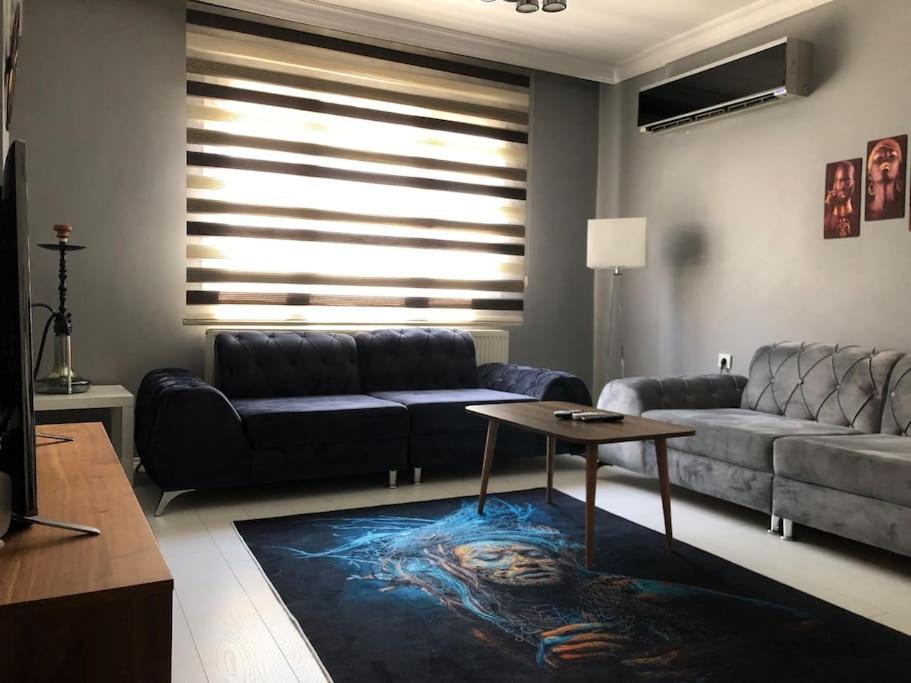 a living room with a couch and a table at City center home in Karataş