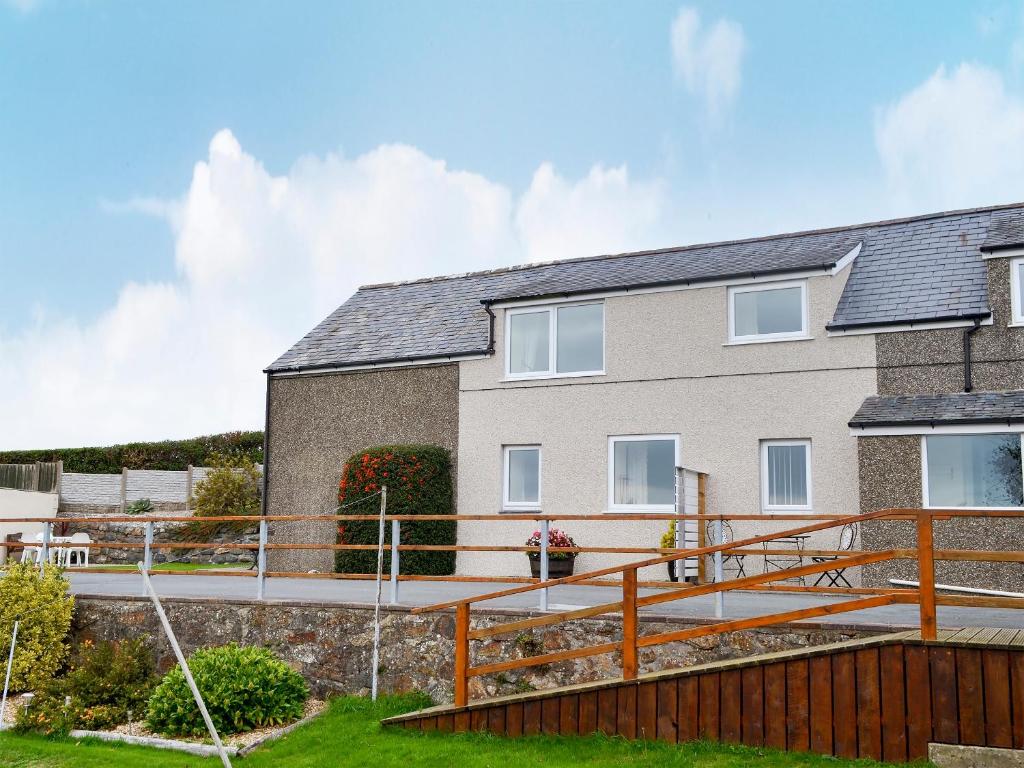 a house with a large deck in front of it at Fron Erch Cottages - 2711 in Llanarmon