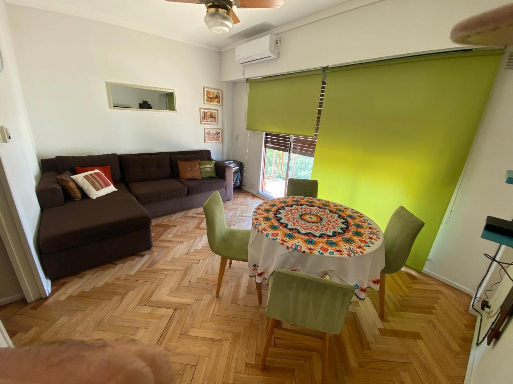 sala de estar con mesa y sofá en Acogedor departamento en Caballito en Buenos Aires