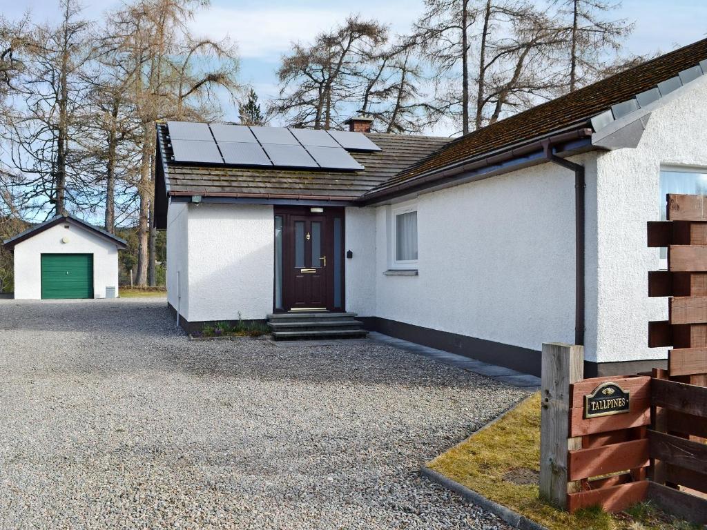 a house with solar panels on the roof at Tall Pines in Carrbridge
