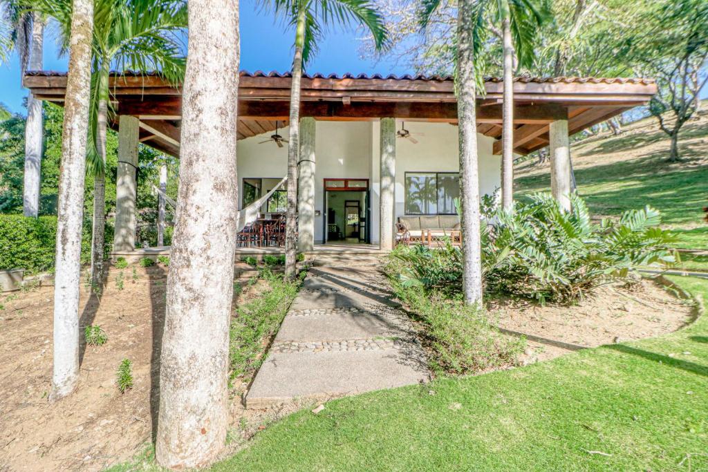 a house with palm trees in front of it at Casa Carmen in Potrero