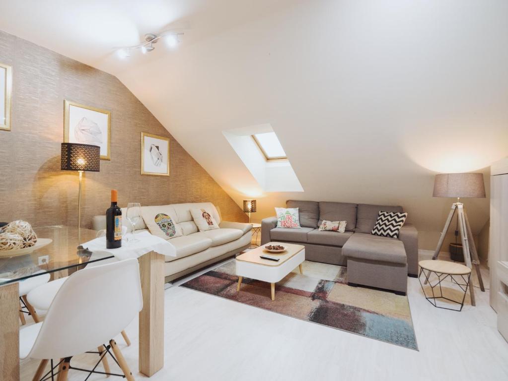 a living room with a couch and a table at Apartamento "RASCALINDES" in Tordesillas