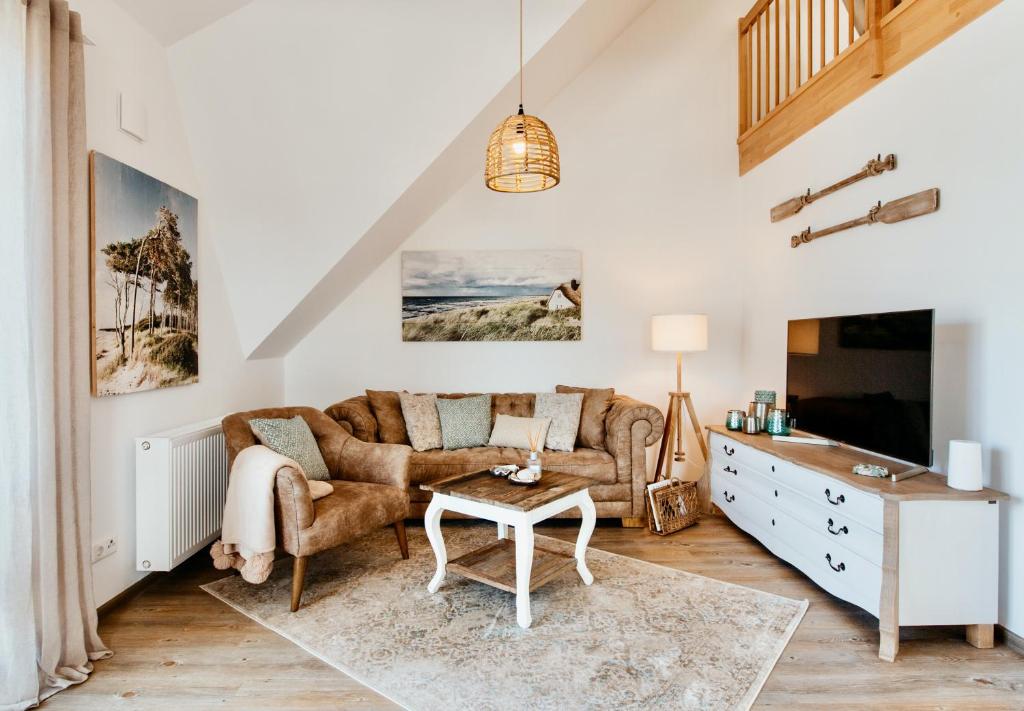 a living room with a couch and a table at Ostseeblau in Zingst