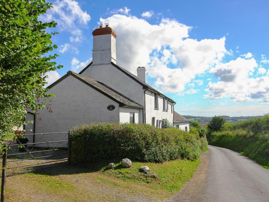 a white house on the side of a road at Oddwell Cottage in Brompton Ralph