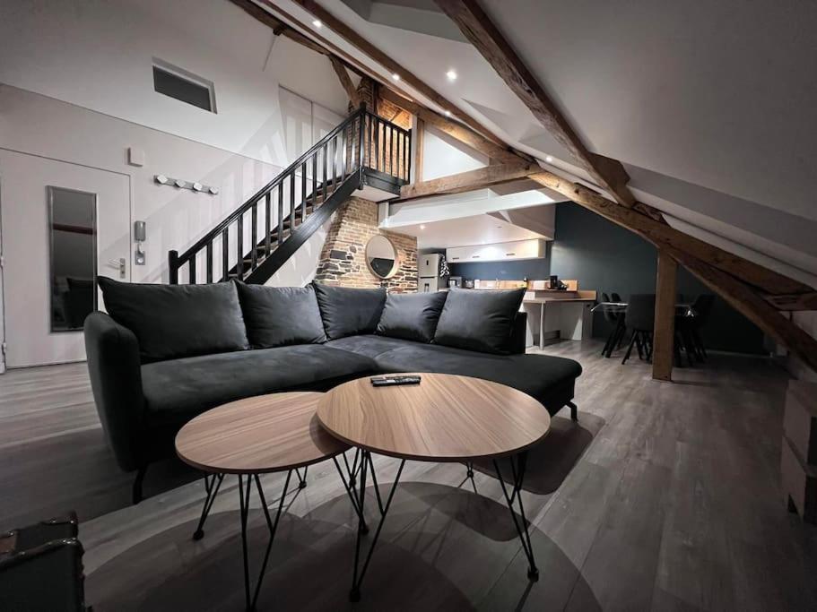 een woonkamer met een bank en een tafel bij Appartement Little Stuart in Dol-de-Bretagne