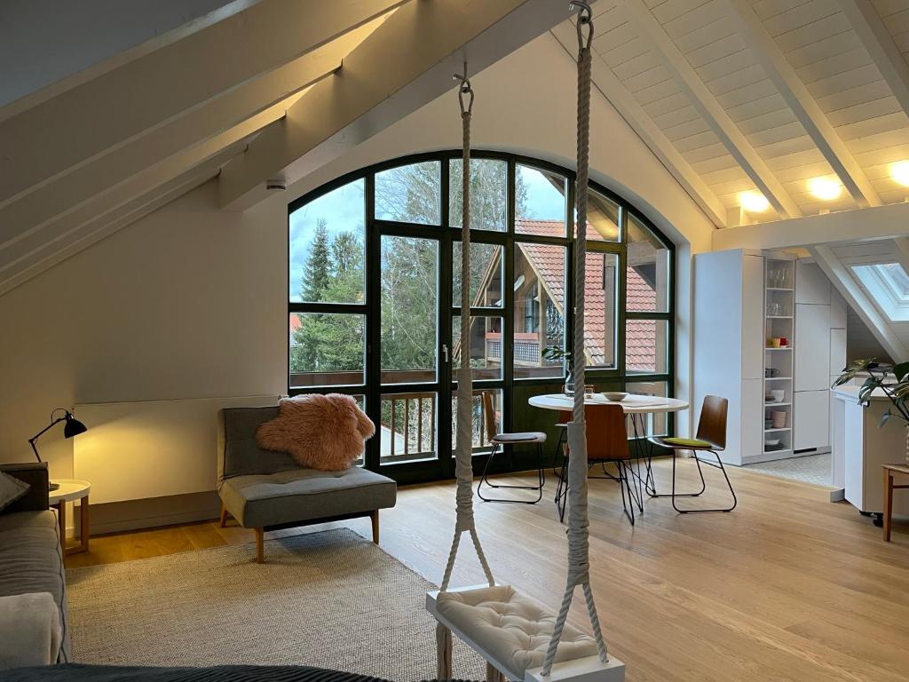 a living room with a couch and a swing at Gemütliches Loft in Geretsried