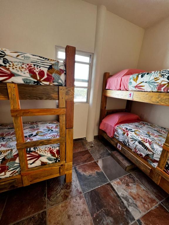Postel nebo postele na pokoji v ubytování Hostal Bucerias