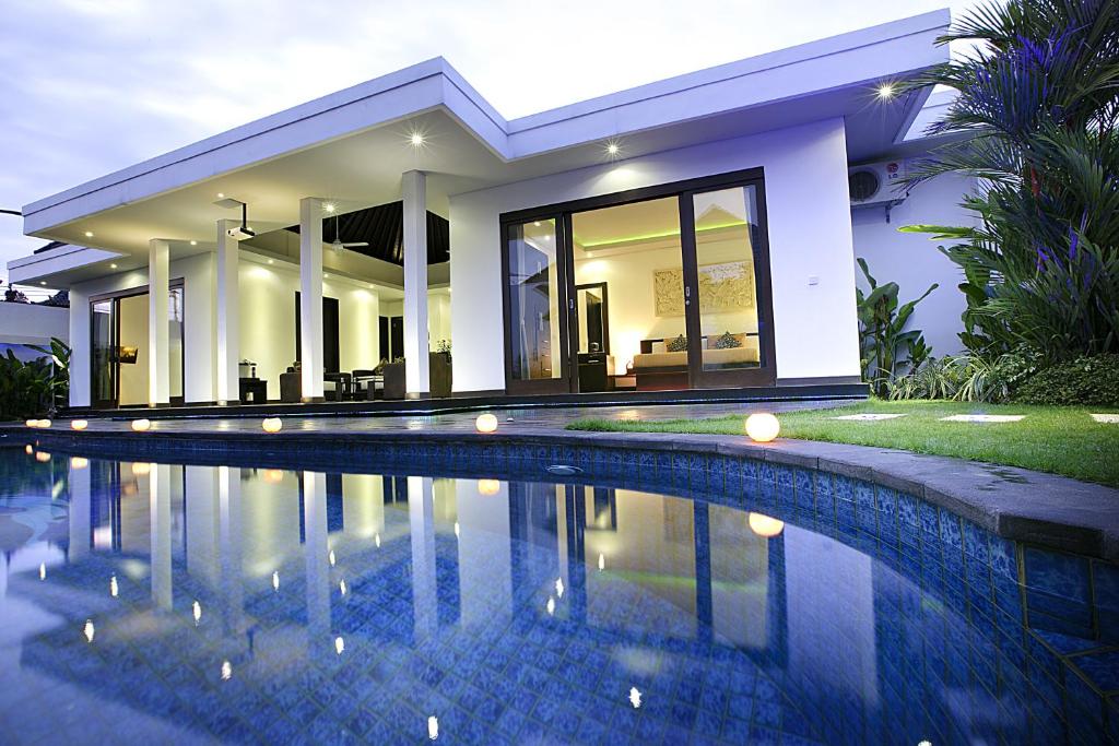 a house with a swimming pool in front of it at D&G Villas Nusa Dua in Nusa Dua