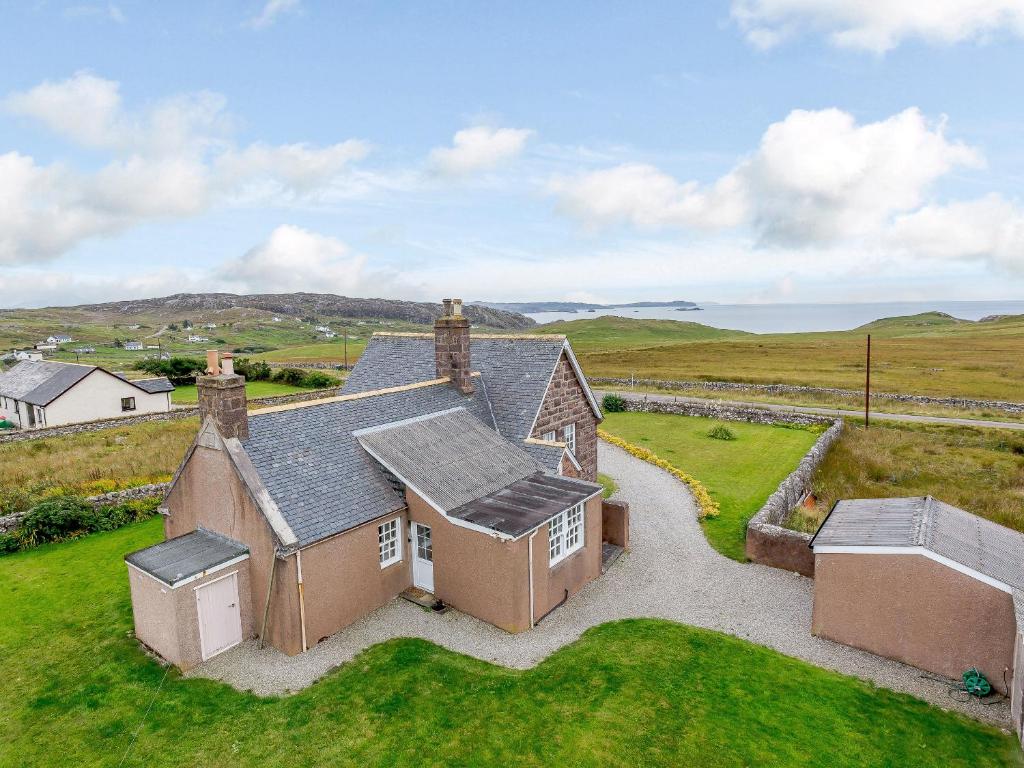 an aerial view of an old house in a field at The Old School House in Oldshore